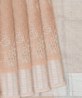 Light Peach Woven Linen Saree With Embroidered Floral Motifs
