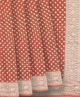 Rust Handwoven Khaddi Geirgette Silk Saree With Floral Motifs & Vine Motifs in Border
